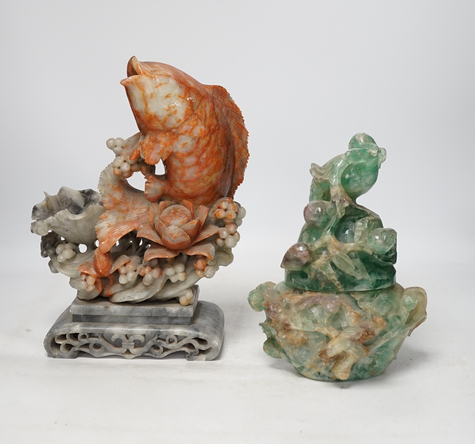 A Chinese carved soapstone figure of a leaping carp and a green quartz pot and cover, tallest 29.5cm high. Condition - fair
